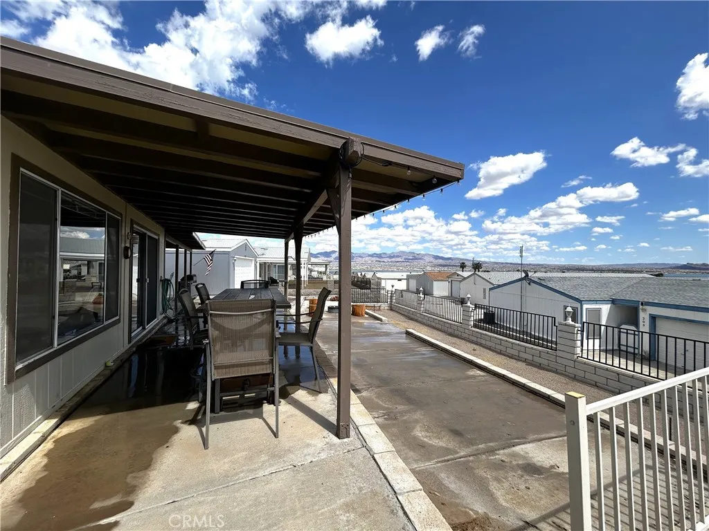 2 Havasu Lake Road, Unit 2 Needles, CA 92363 - Photo 4 of 17 a view of a patio with table and chairs and potted plants