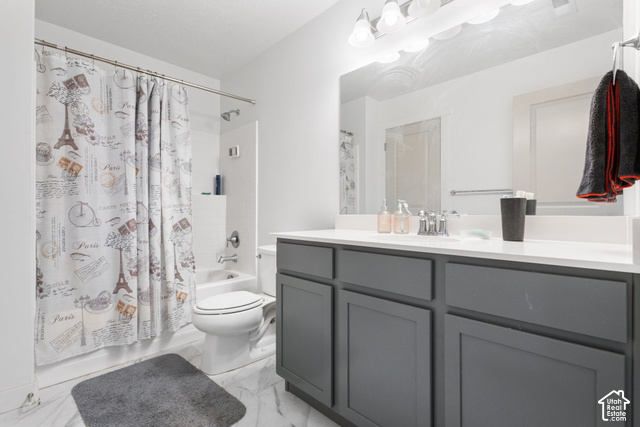 7723 Conger Road Magna, UT 84044 - Photo 11 of 24 Full bathroom with a tub/shower combination, a vanity with a white countertop, and a large mirror