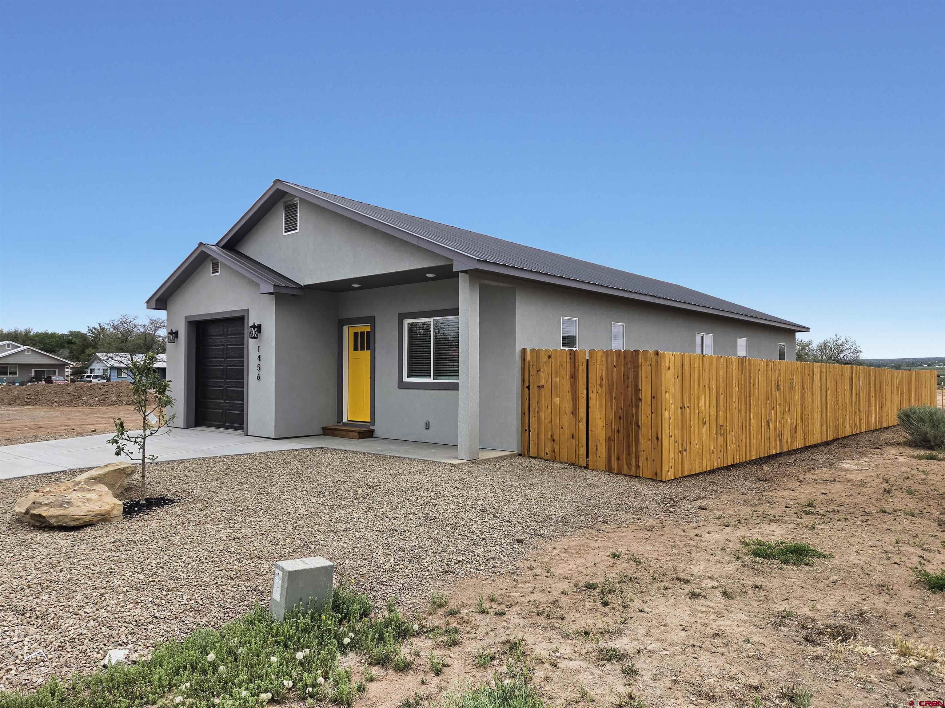 1456 Acoma Street Cortez, CO 81321 - Photo 2 of 26 a view of a house with backyard and a tree