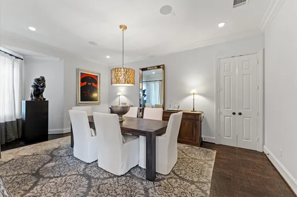 a dining room with furniture a rug and wooden floor