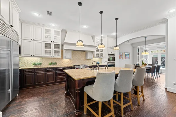 a large kitchen with a table and chairs