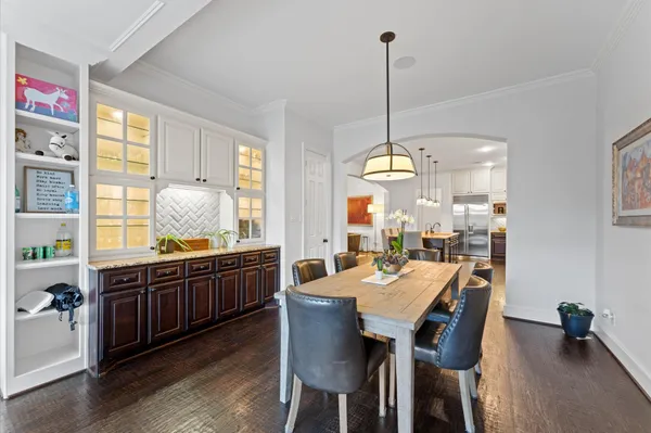a large kitchen with a table and chairs