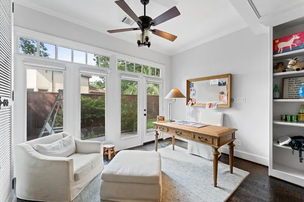 a living room with furniture a flat screen tv and a large window