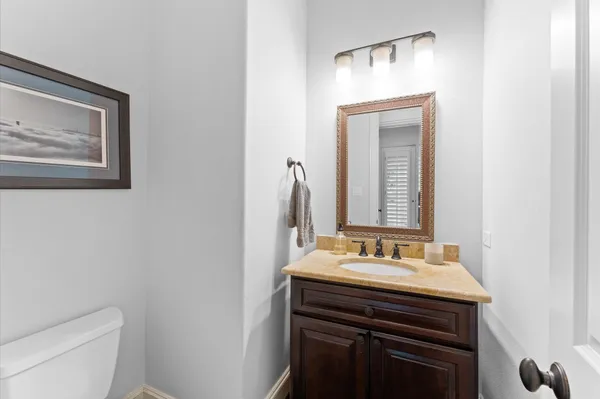 a bathroom with a sink vanity and a toilet