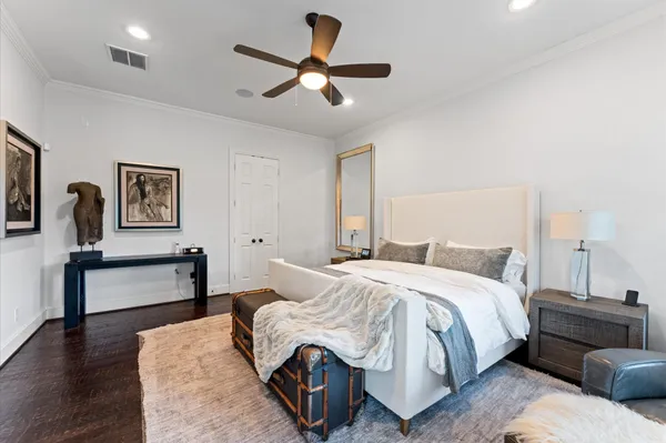 a bedroom with a bed large mirror and couch