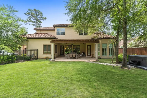 a front view of a house with a garden and patio