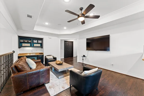 a living room with furniture kitchen view and a window