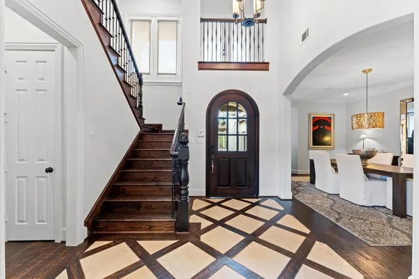 a view of an entryway with wooden floor and livingroom view