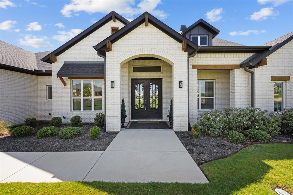 a view of a white house with yard and plants