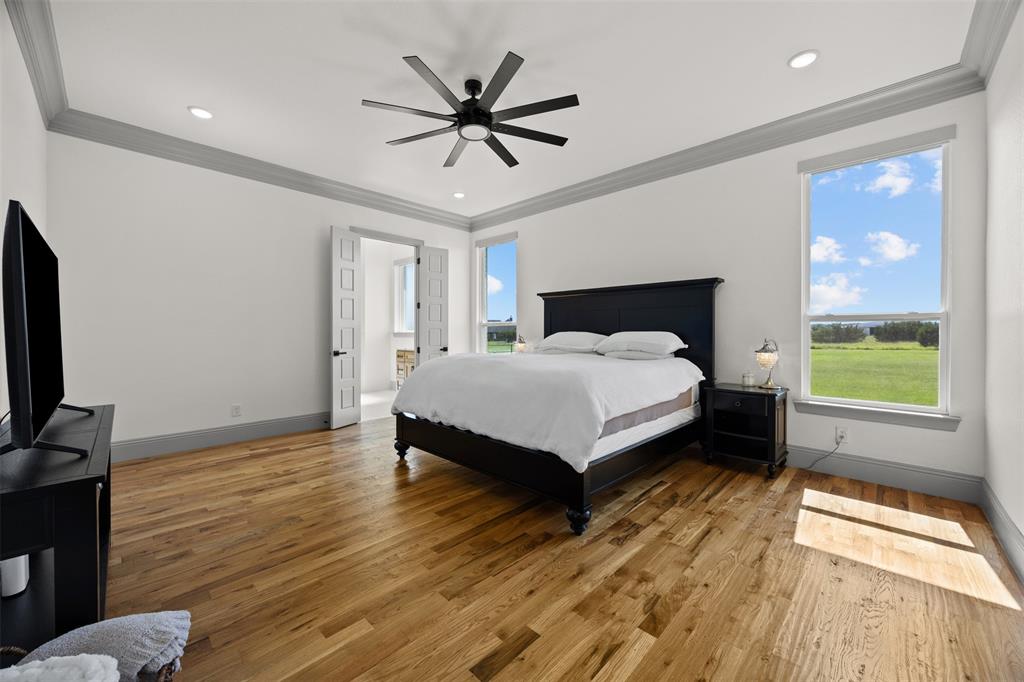 6317 Vega Road Godley, TX 76044 - Photo 12 of 27 a spacious bedroom with a bed and a flat screen tv