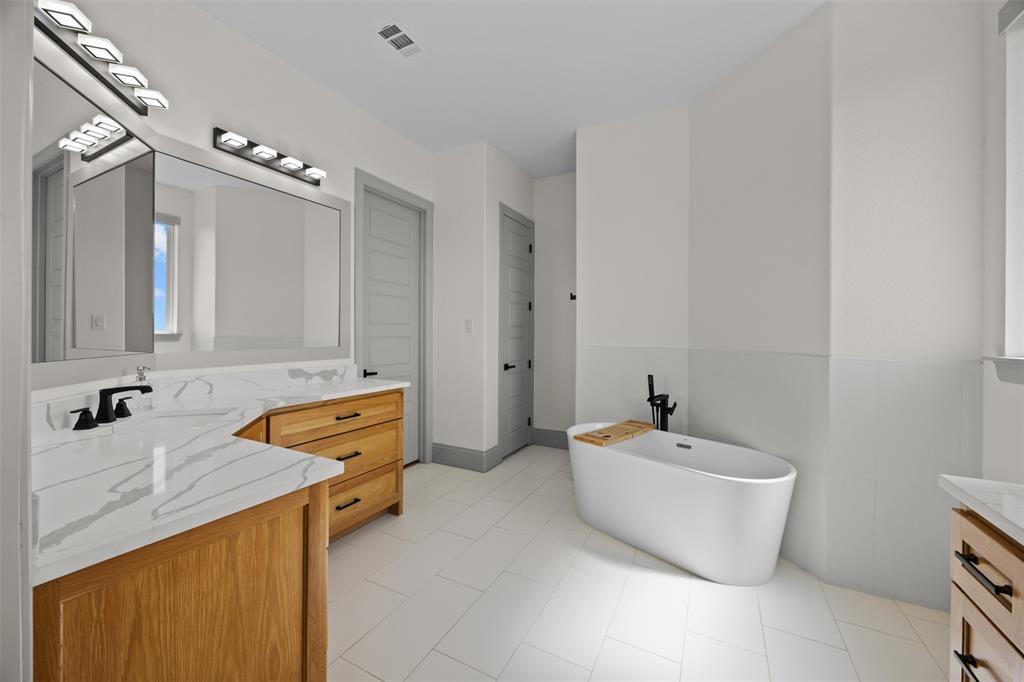 6317 Vega Road Godley, TX 76044 - Photo 14 of 27 a bathroom with a sink and a bathtub