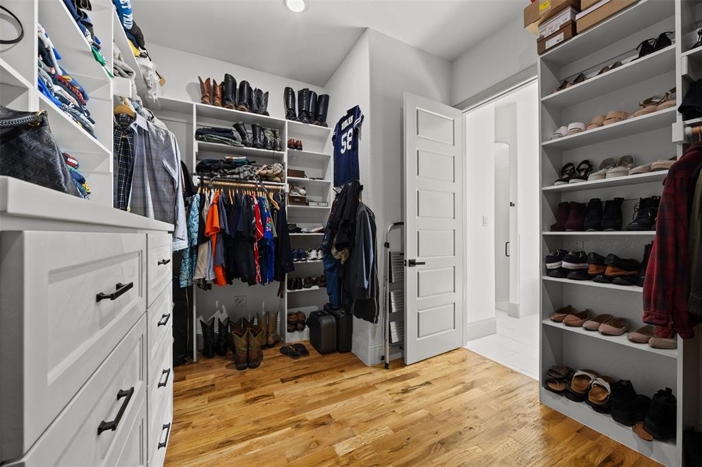 6317 Vega Road Godley, TX 76044 - Photo 17 of 27 a view of walk in closet with clothes and shoes