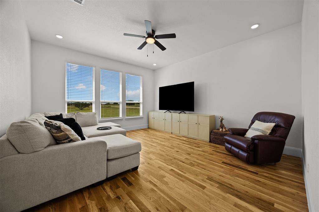 6317 Vega Road Godley, TX 76044 - Photo 18 of 27 a living room with furniture and a flat screen tv