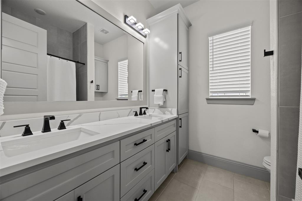 6317 Vega Road Godley, TX 76044 - Photo 21 of 27 a bathroom with a double vanity sink and mirror
