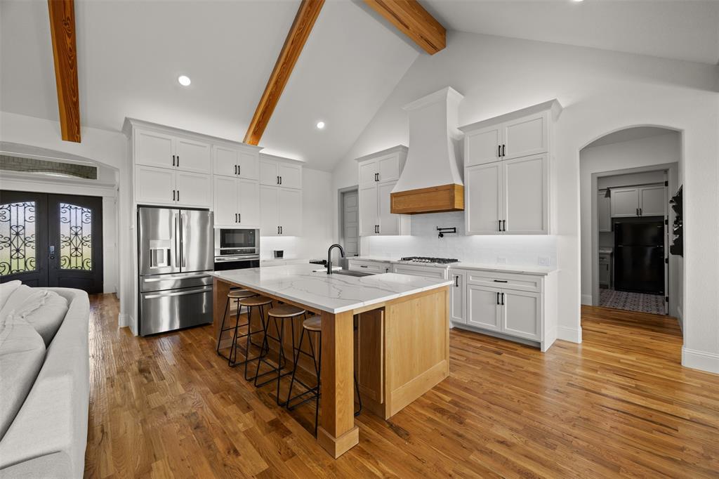 6317 Vega Road Godley, TX 76044 - Photo 10 of 27 a kitchen with stainless steel appliances a stove top oven a sink dishwasher a refrigerator and cabinets with wooden floor