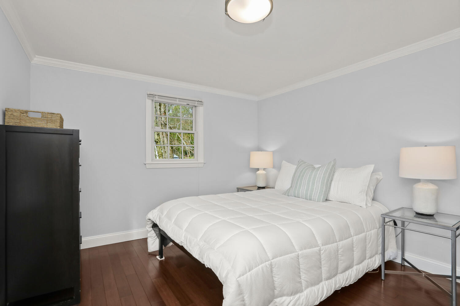 86 West Avenue Darien, CT 06820 - Photo 23 of 32 a bedroom with a bed and a lamp