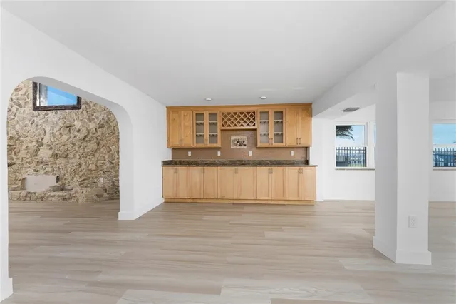 a large white kitchen with a stove a sink dishwasher and a refrigerator