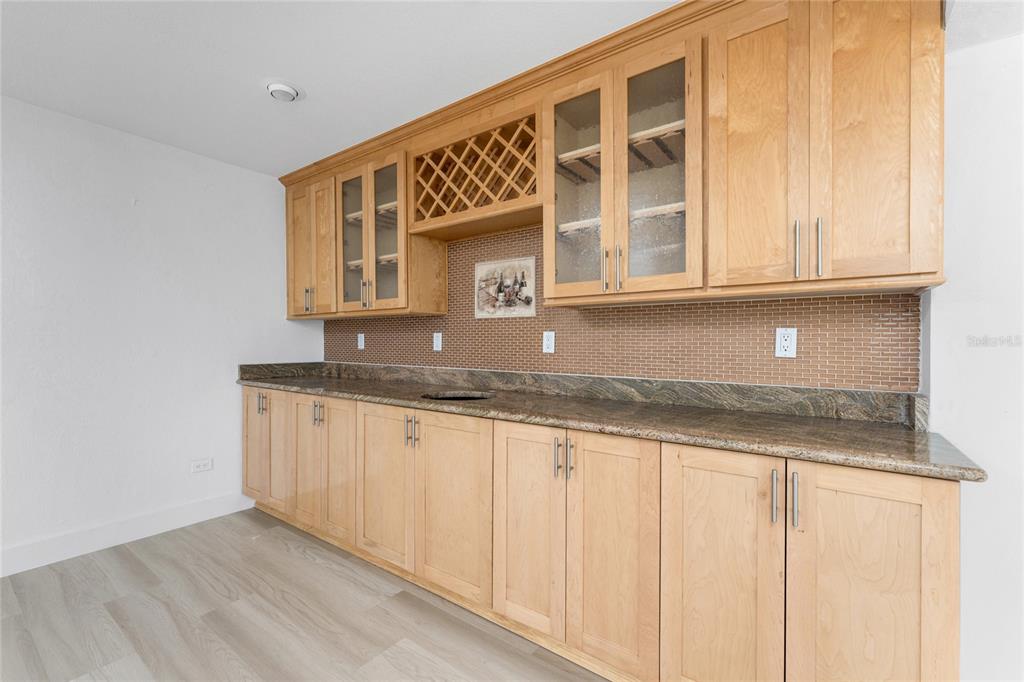 341 Severin Road Southeast Port Charlotte, FL 33952 - Photo 16 of 90 a kitchen with granite countertop white cabinets and sink