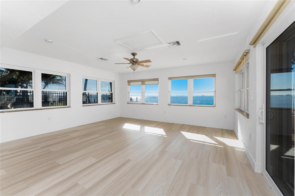 341 Severin Road Southeast Port Charlotte, FL 33952 - Photo 18 of 90 a view of an empty room with window and wooden floor