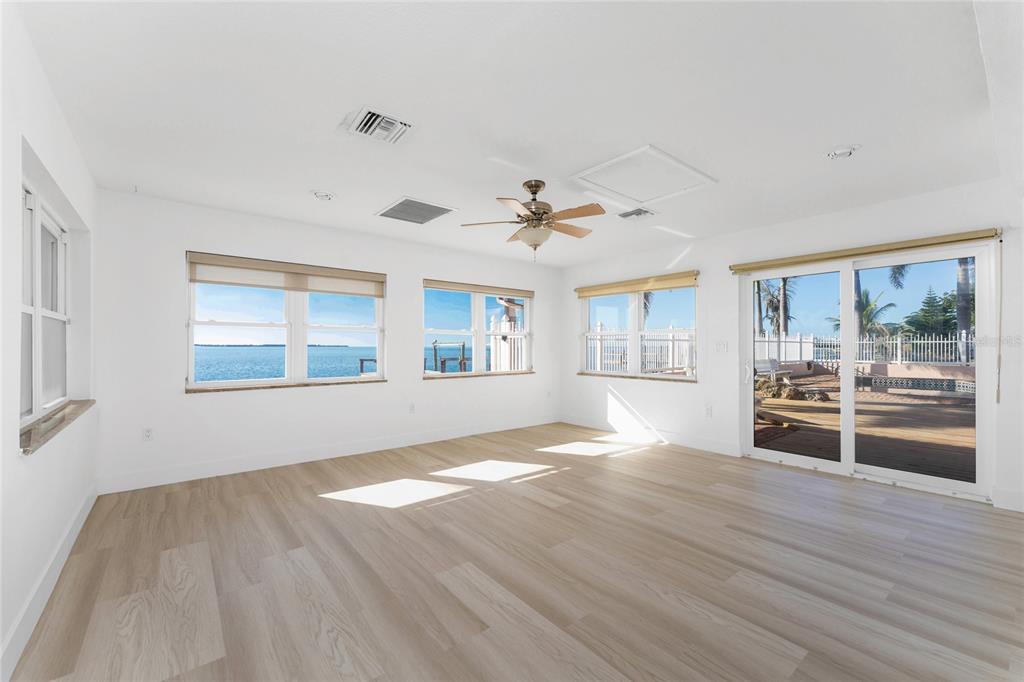 341 Severin Road Southeast Port Charlotte, FL 33952 - Photo 19 of 90 a view of empty room with wooden floor and fan