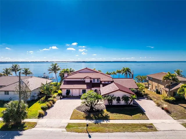 an aerial view of a house with garden space and street view