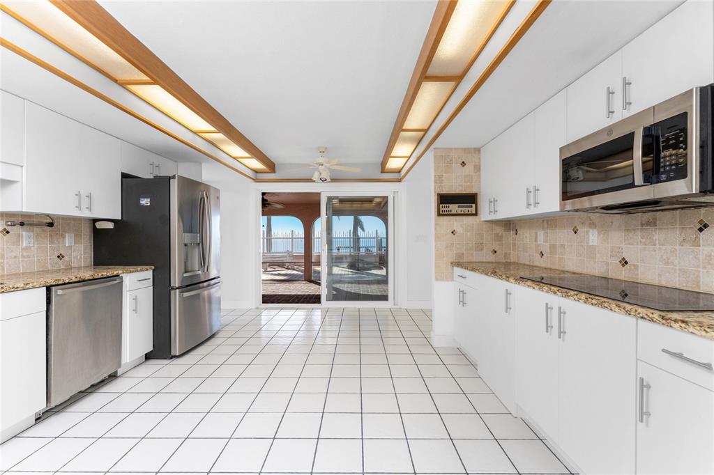 341 Severin Road Southeast Port Charlotte, FL 33952 - Photo 24 of 90 a kitchen with stainless steel appliances granite countertop a refrigerator and a stove top oven