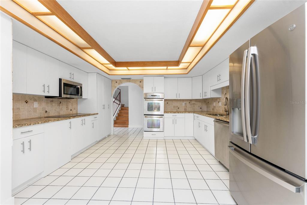 341 Severin Road Southeast Port Charlotte, FL 33952 - Photo 26 of 90 a large white kitchen with a stove a sink dishwasher and a refrigerator