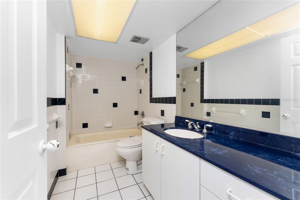 341 Severin Road Southeast Port Charlotte, FL 33952 - Photo 36 of 90 a bathroom with a sink a toilet and a large mirror