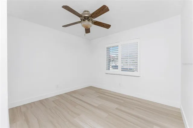 a view of a hallway with a large window and a chandelier