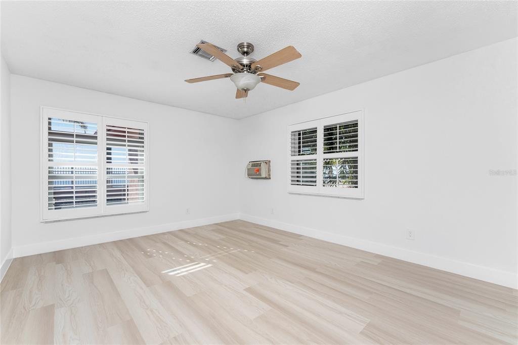 341 Severin Road Southeast Port Charlotte, FL 33952 - Photo 49 of 90 a view of a livingroom with a ceiling fan and wooden floor