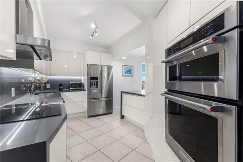 a kitchen with a refrigerator and a sink