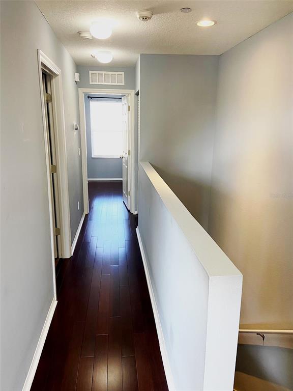 8946 White Sage Loop Lakewood Ranch, FL 34202 - Photo 23 of 36 a view of a hallway with wooden floor