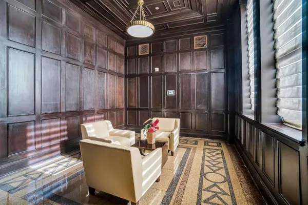 a living room with furniture and a kitchen view