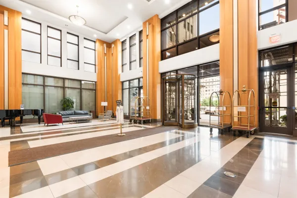 a lobby with furniture and large windows