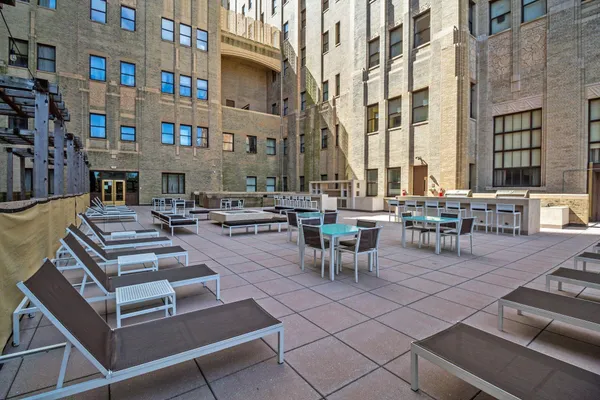 a view of a patio with dining table and chairs