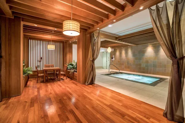 a view of a room with wooden floor and windows