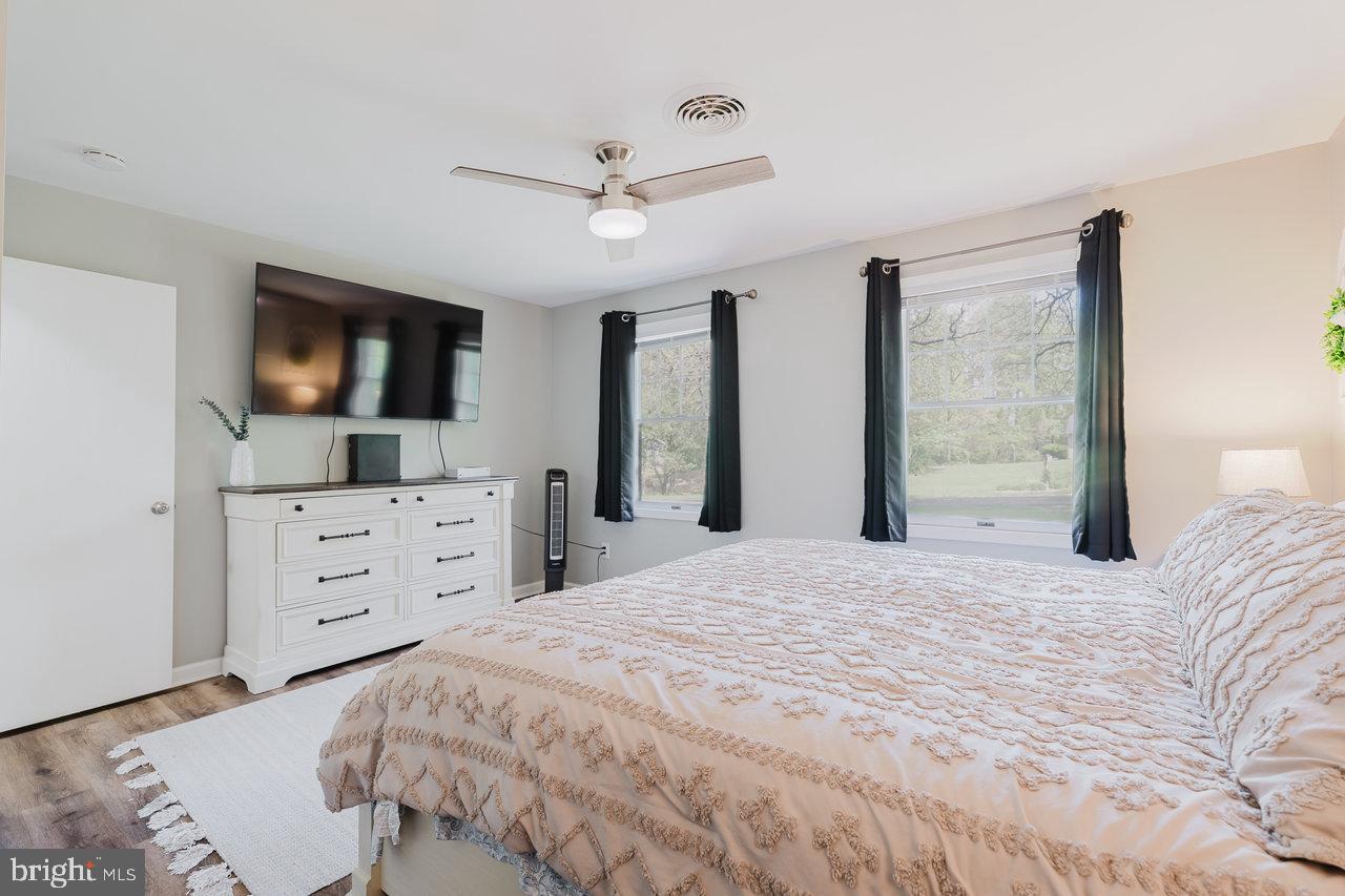 119 Canal Road Falling Waters, WV 25419 - Photo 24 of 66 a bedroom with a bed a window and a flat screen tv