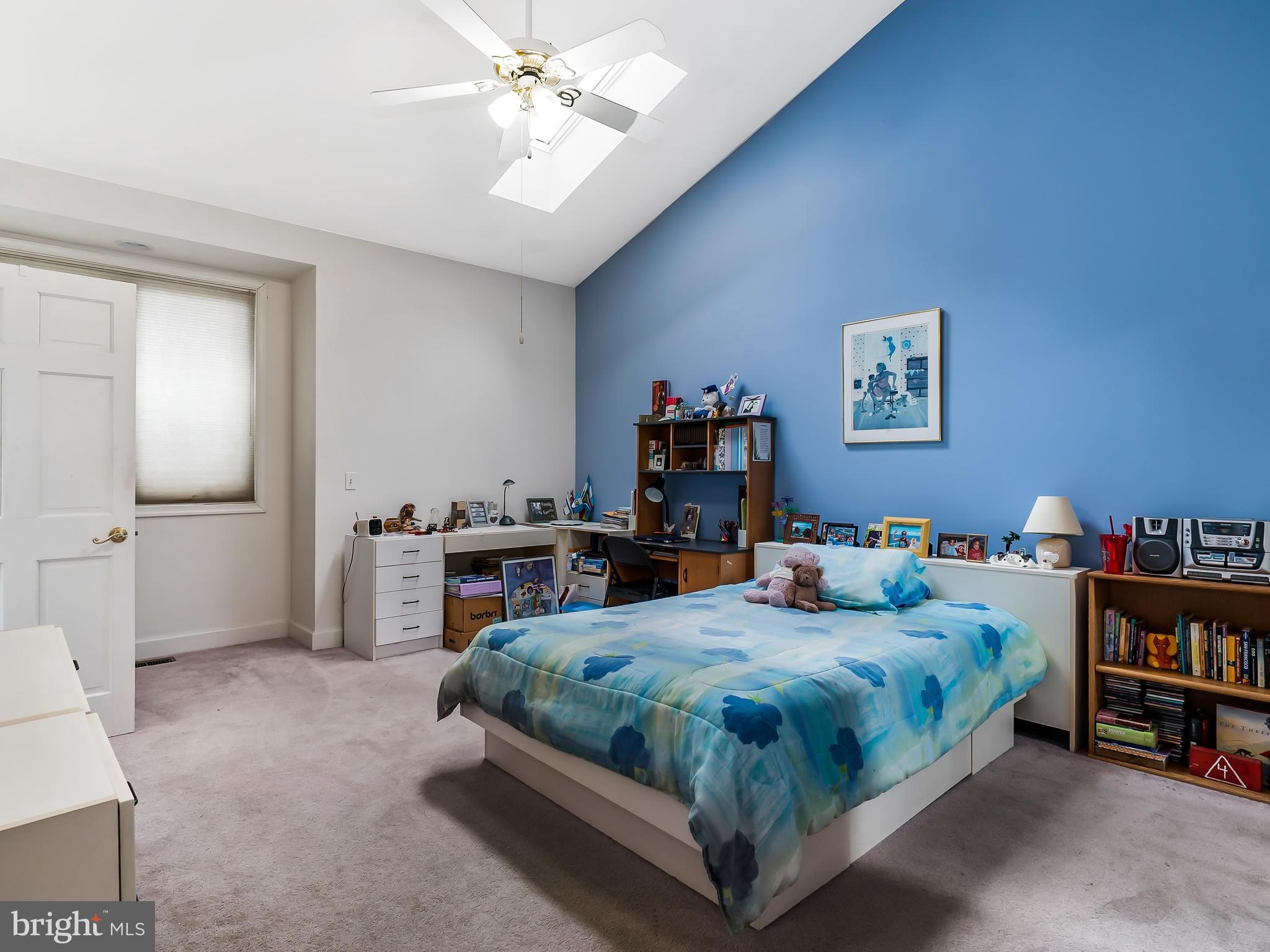 175 Norwood Road Silver Spring, MD 20905 - Photo 14 of 30 a bedroom with a bed and a book shelf