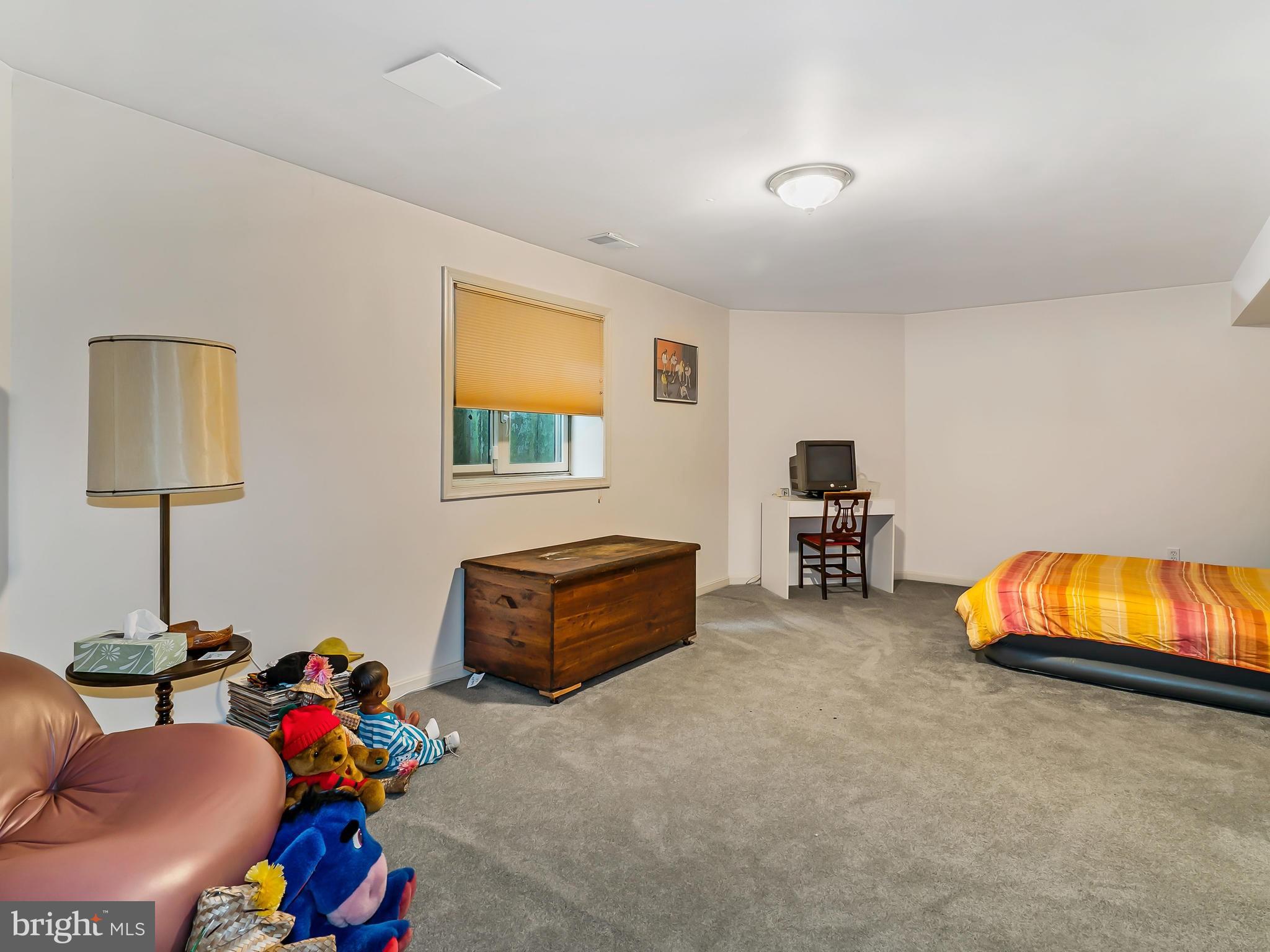175 Norwood Road Silver Spring, MD 20905 - Photo 19 of 30 a bedroom with furniture and a lamp