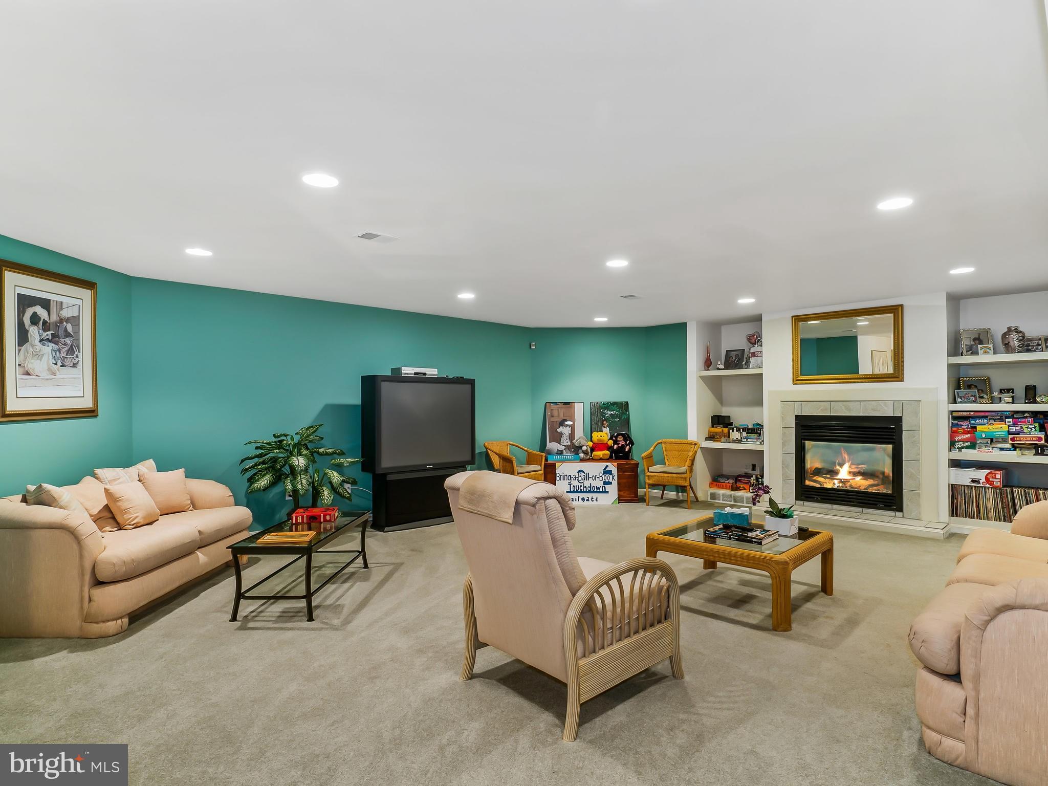 175 Norwood Road Silver Spring, MD 20905 - Photo 22 of 30 a living room with furniture a fireplace and a flat screen tv