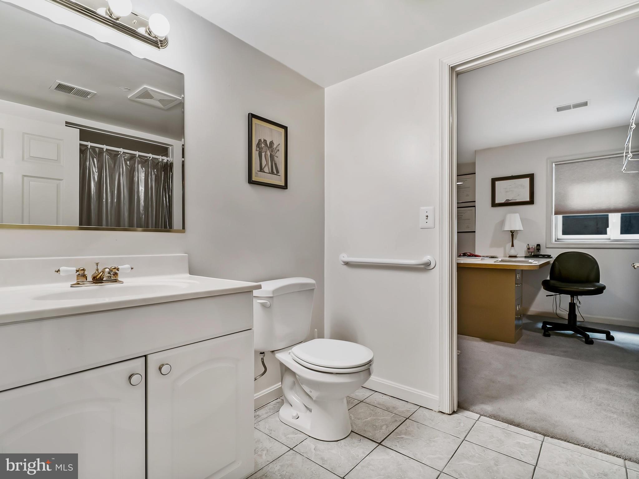 175 Norwood Road Silver Spring, MD 20905 - Photo 26 of 30 a bathroom with a toilet a sink and mirror