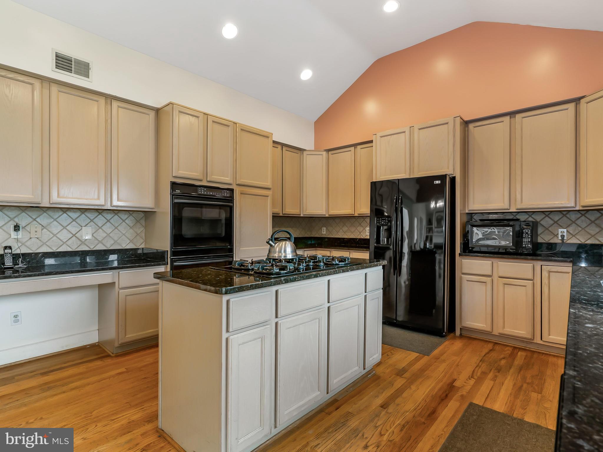 175 Norwood Road Silver Spring, MD 20905 - Photo 9 of 30 a kitchen with granite countertop a refrigerator stove and microwave