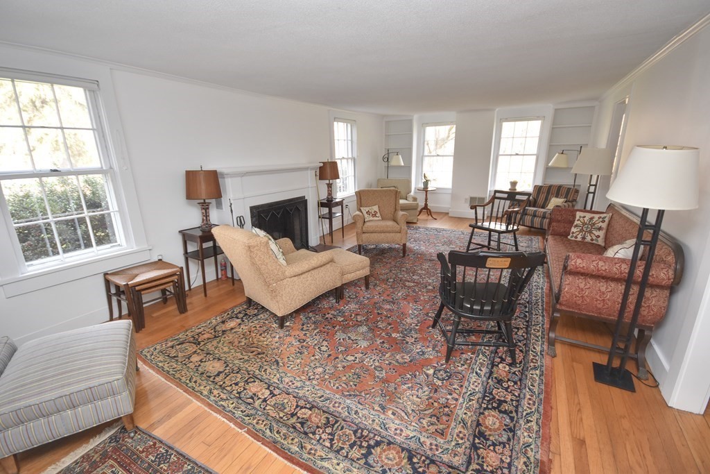 344 Flat Hills Road Amherst, MA 01002 - Photo 12 of 42 a living room with furniture a fireplace and a large window