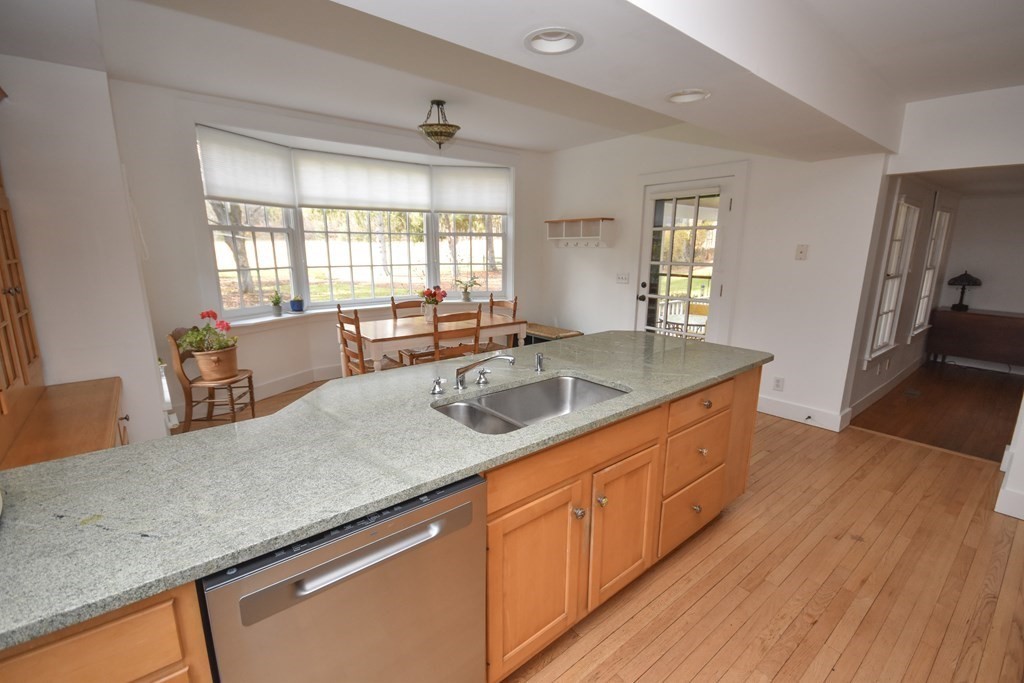 344 Flat Hills Road Amherst, MA 01002 - Photo 19 of 42 a kitchen with stainless steel appliances granite countertop a sink a counter space and wooden floor