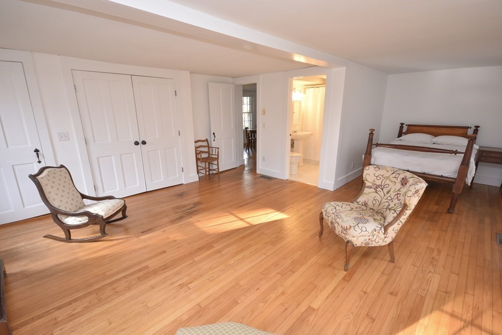 344 Flat Hills Road Amherst, MA 01002 - Photo 22 of 42 a view of a hallway with wooden floor and chair