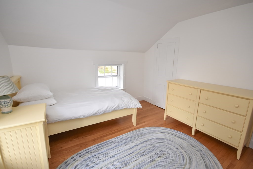 344 Flat Hills Road Amherst, MA 01002 - Photo 25 of 42 a bedroom with a bed and wooden floor