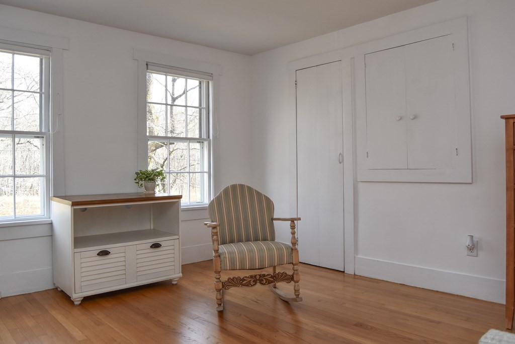 344 Flat Hills Road Amherst, MA 01002 - Photo 28 of 42 an empty room with a window and wooden floor