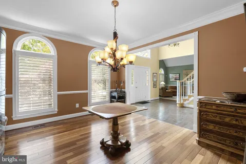 a living room with furniture and painting on the wall