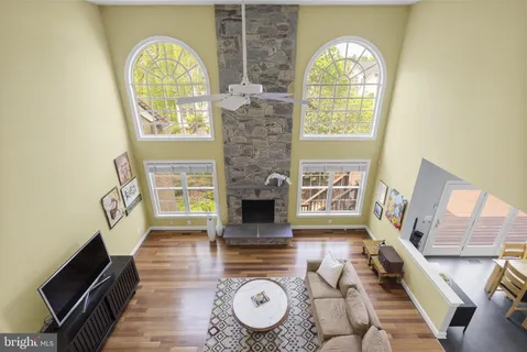 a living room with furniture a flat screen tv and a large window
