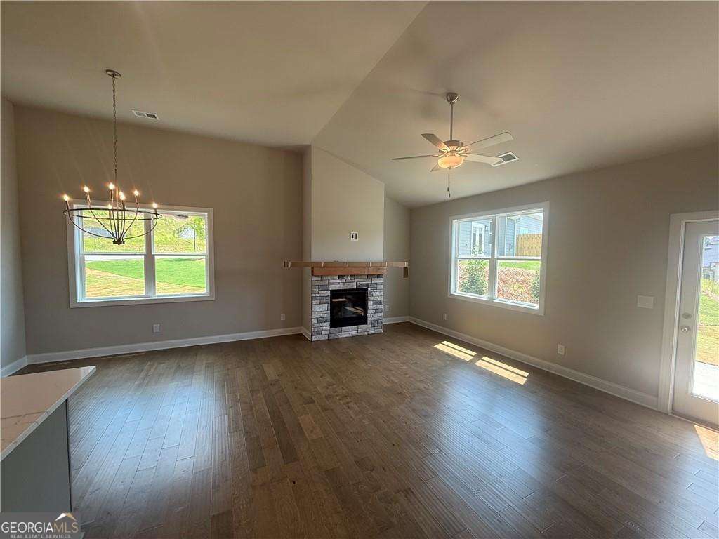 352 Lakeside Drive Canton, GA 30115 - Photo 8 of 16 an empty room with wooden floor chandelier fan and windows